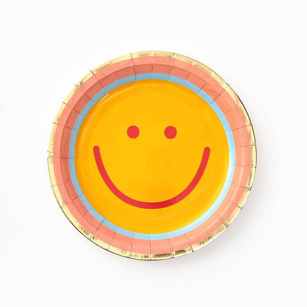 Smiley face paper plate with gold rim on a white background