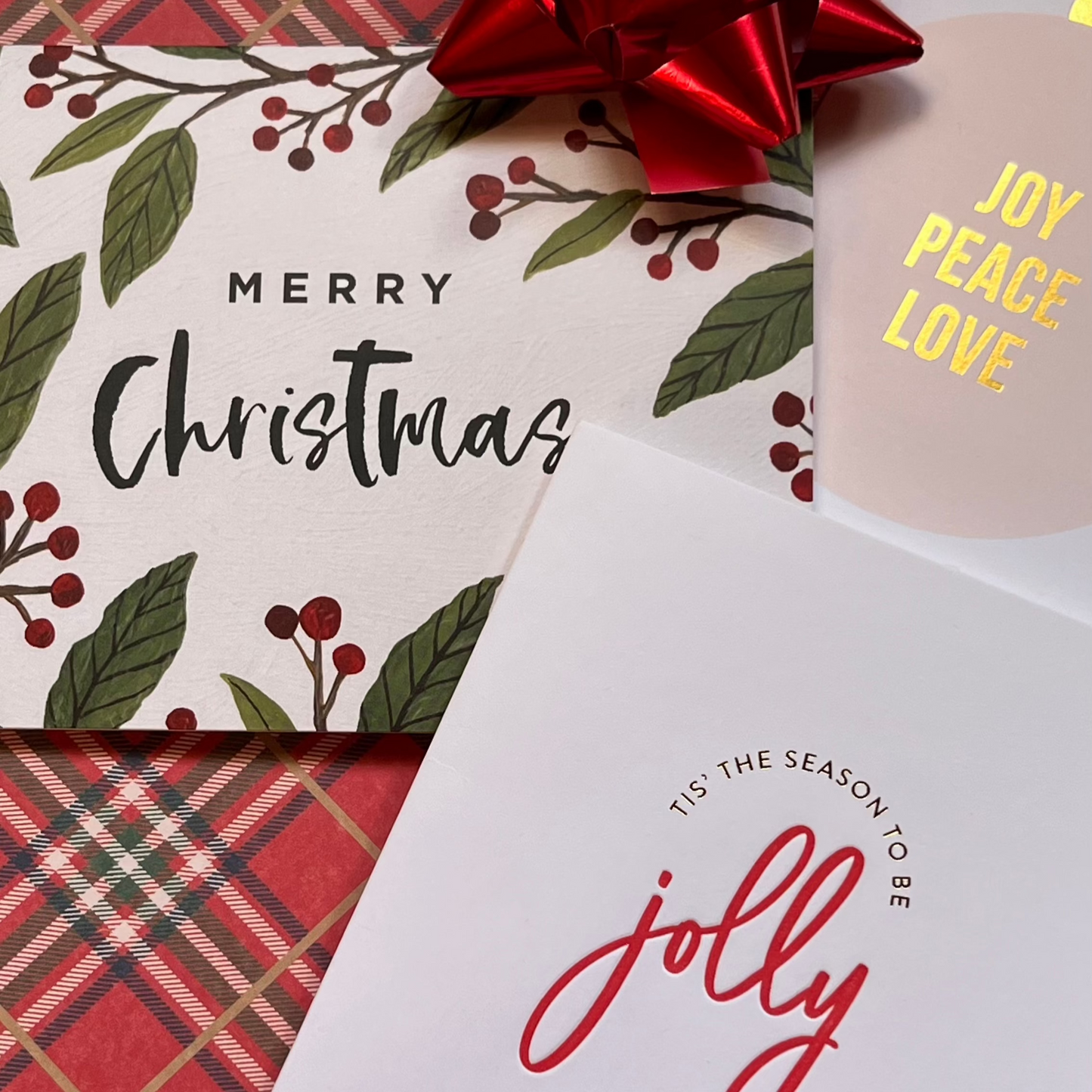 Image of 3 Christmas greeting cards on a plaid background