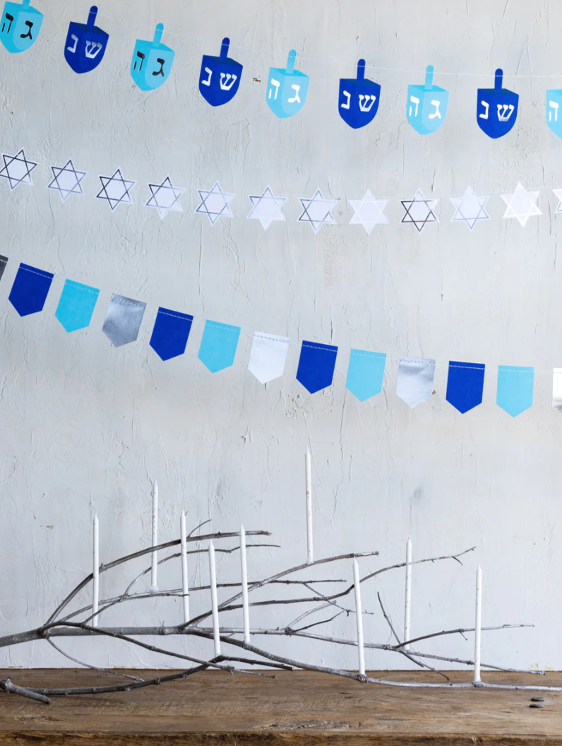 Hannukah banner featuring rows of dreidels, stars and pennants