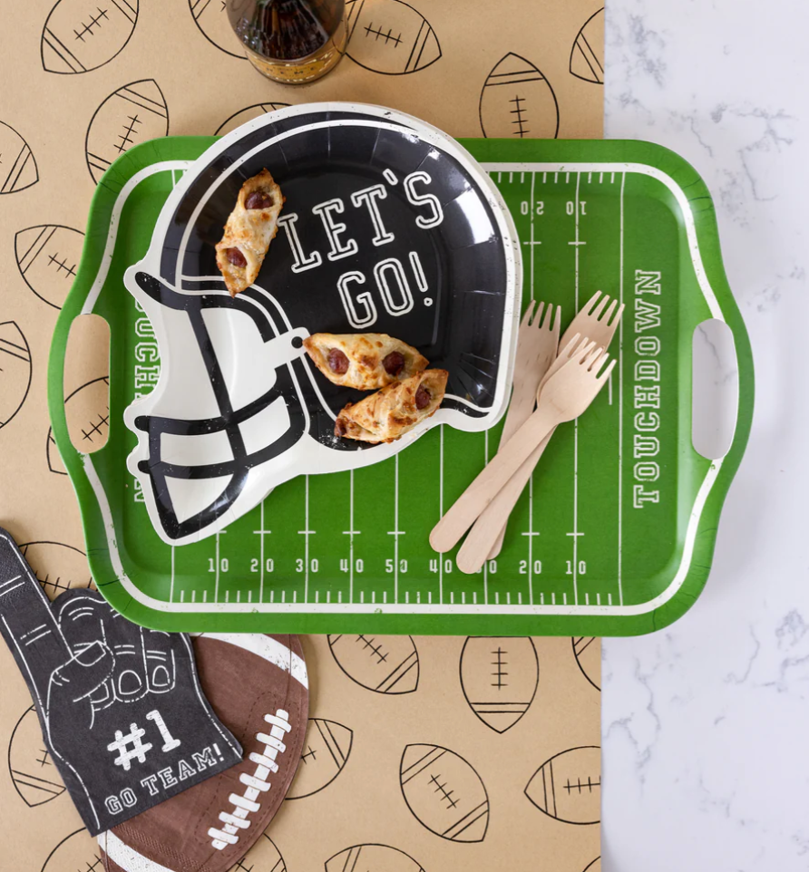 Image of a die-cut football napkin on a party table laydown