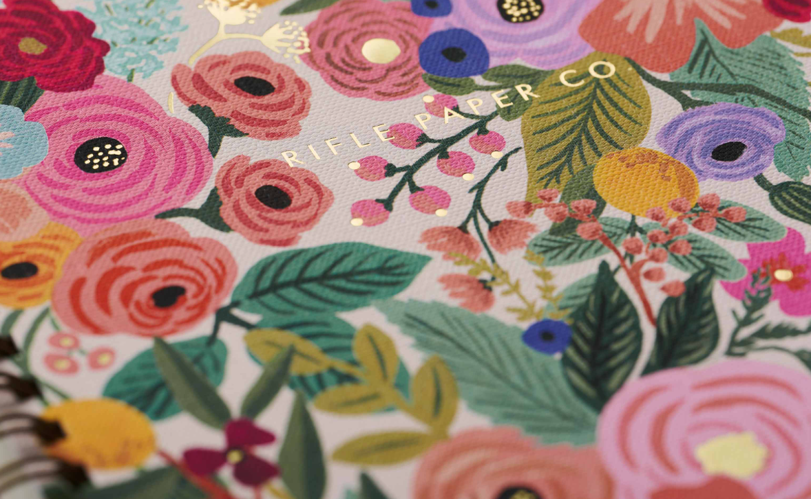 Close up of gold foil branding on front of notebook