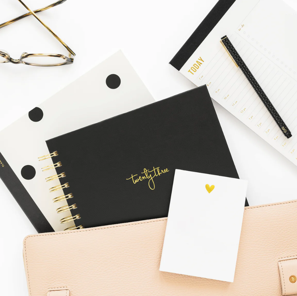 Desk accessories (notebook, notepad, calendar) on a white background