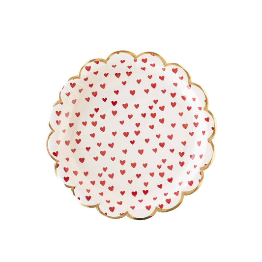 Decorative round scalloped plate with red heart pattern