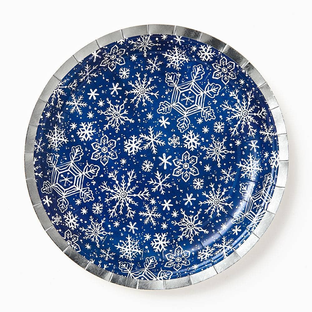 Round paper plate with white snowflake pattern on a blue background