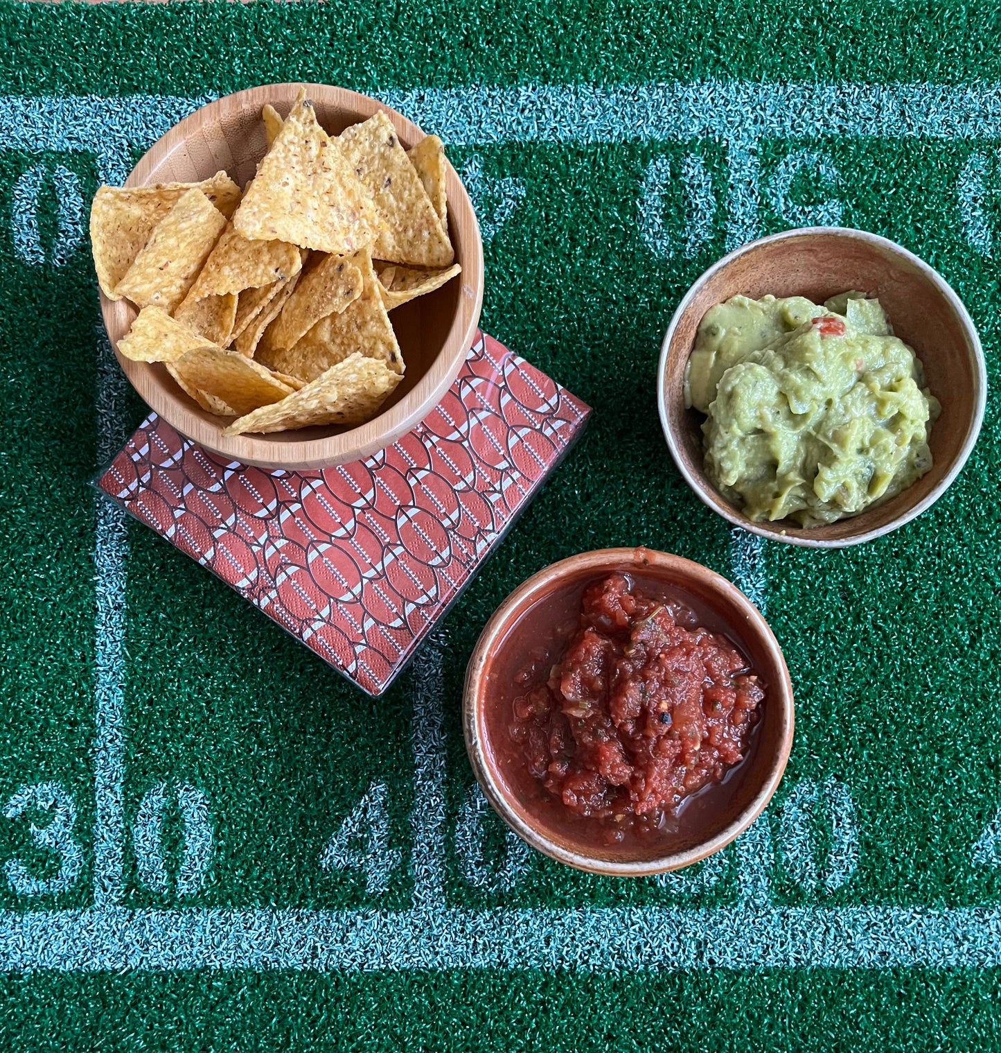 Stack of football napkins next to game day snacks