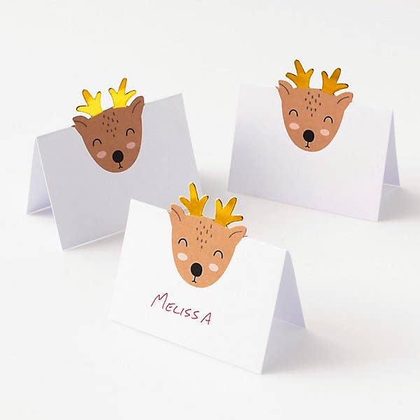 Three small reindeer place cards cards on a white background