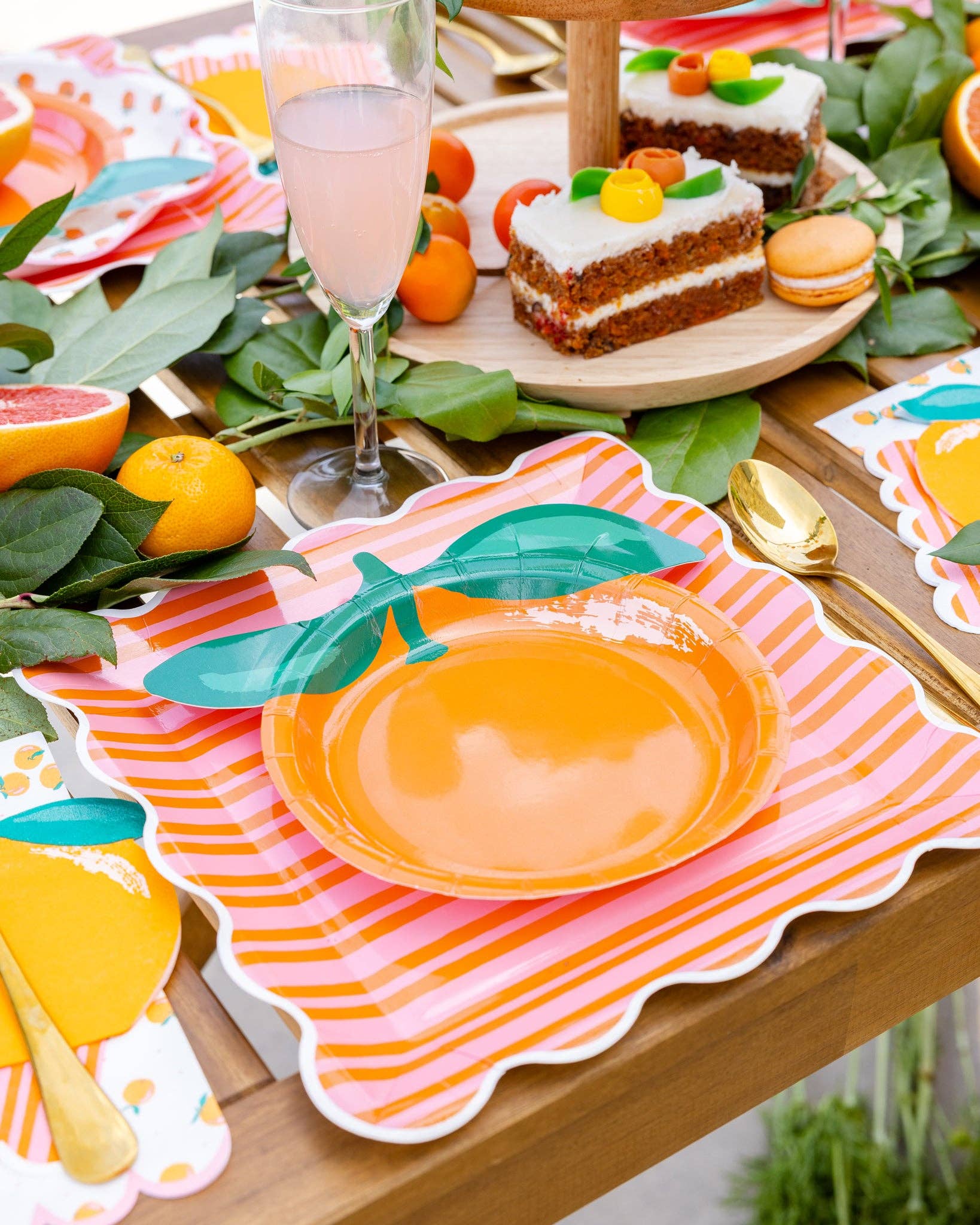 Citrus-themed table setting with orange-shaped plates and decor.