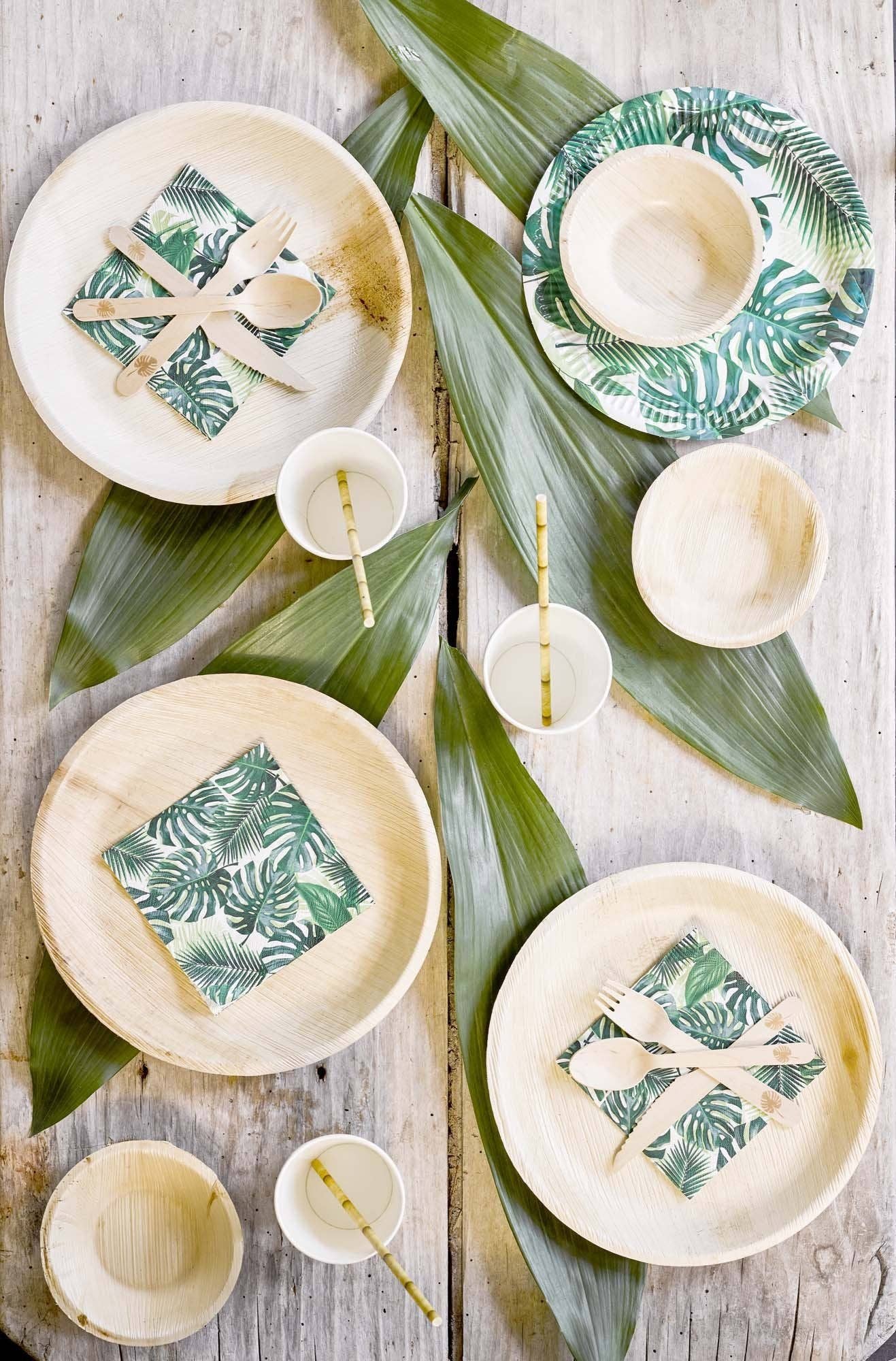 Birds eye view of a tropical table setting with on a wooden surface.
