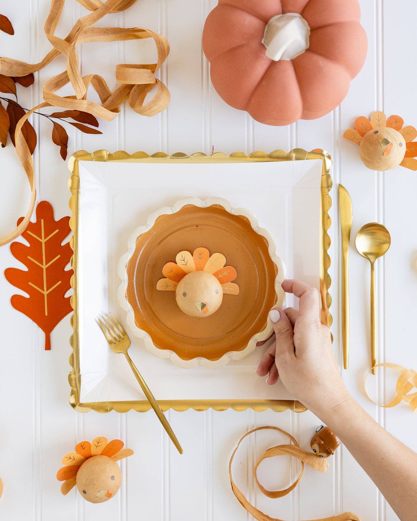 large white square paper plate with gold scalloped edge detail