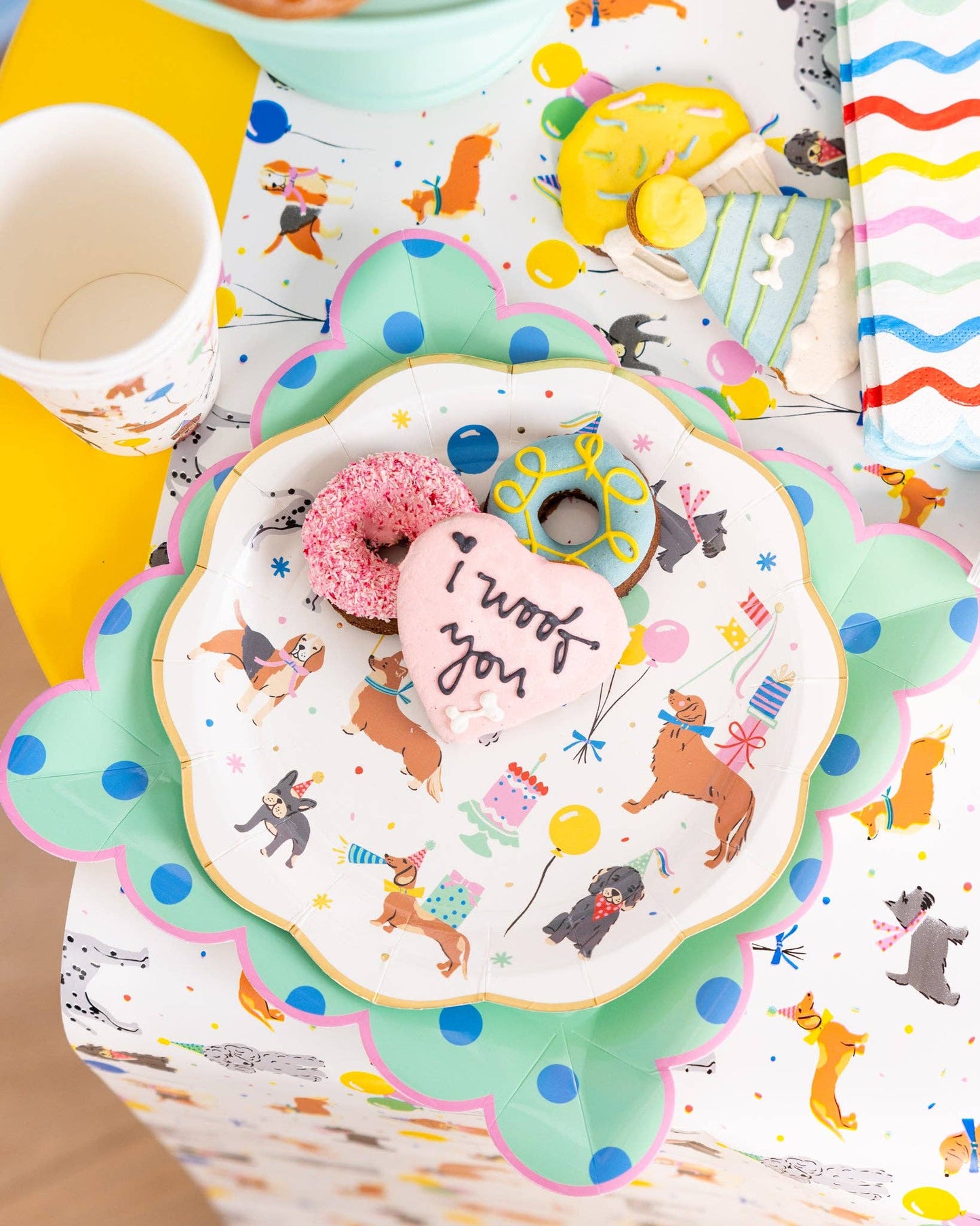 Colorful table setting with a decorative plate featuring dog illustrations