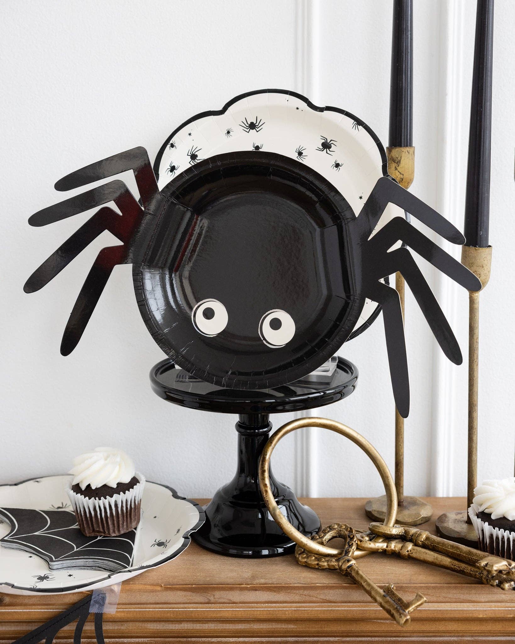 Spider-shaped plate on a table with Halloween-themed decor.