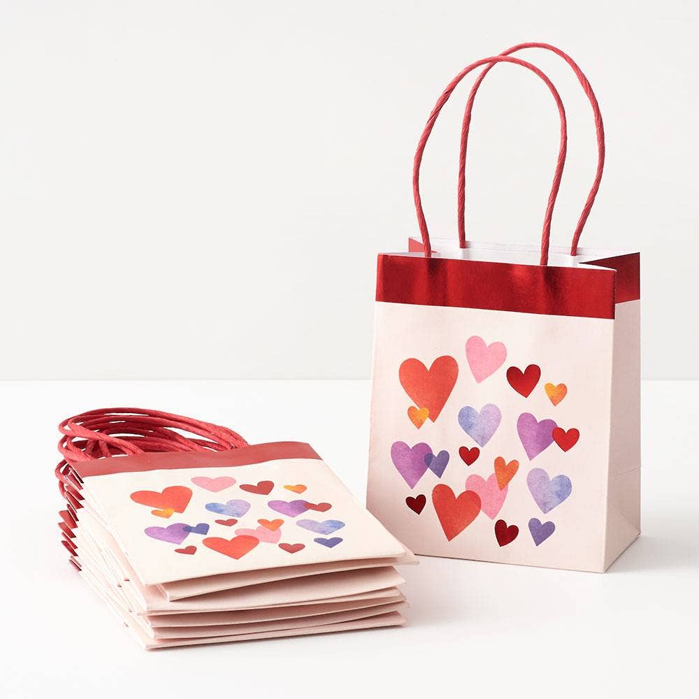Gift bags with heart designs on a white background
