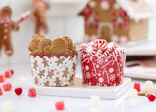 Baking cups with gingerbread men and candy cane designs on a festive background.