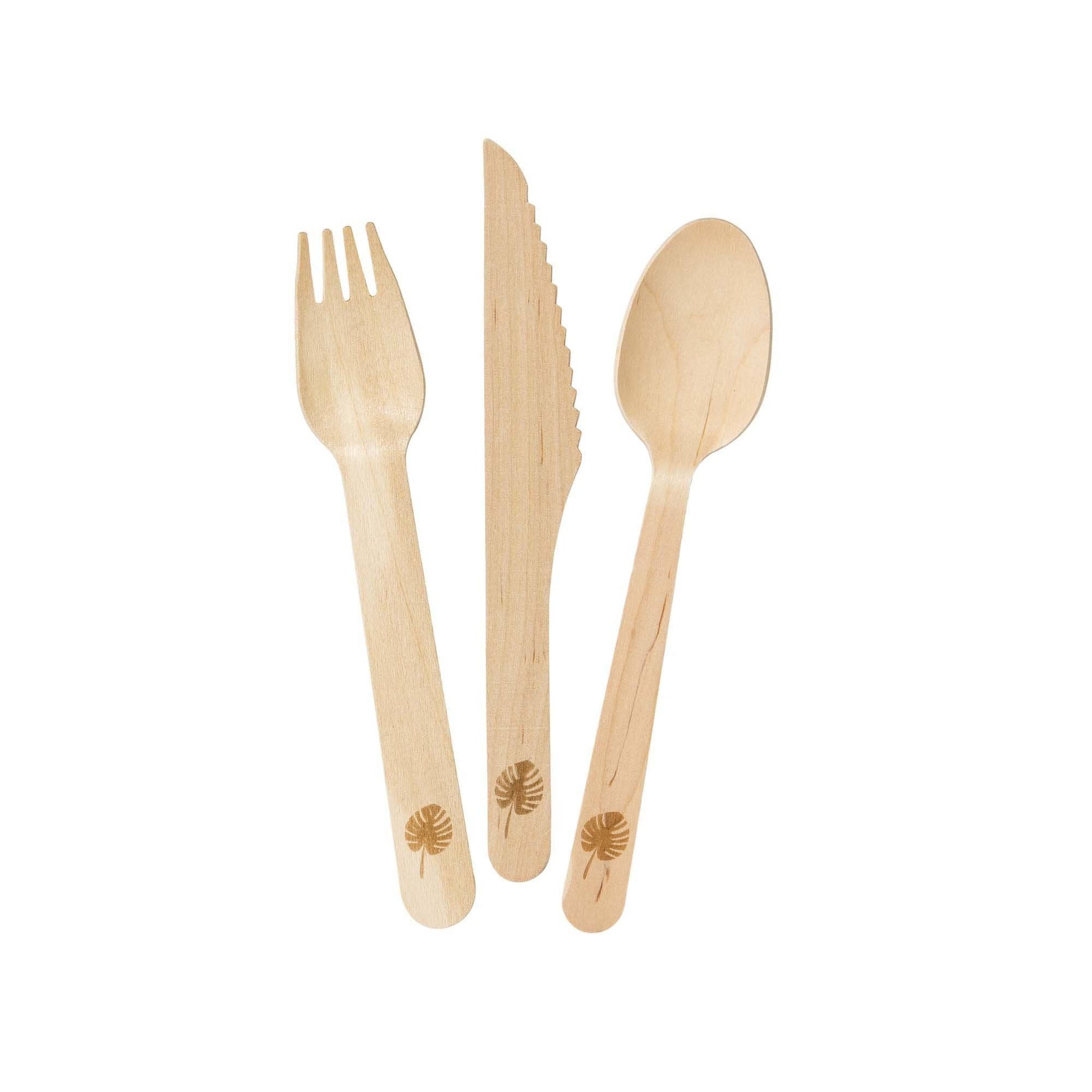 Set of wooden cutlery with etched leaf design on a white background