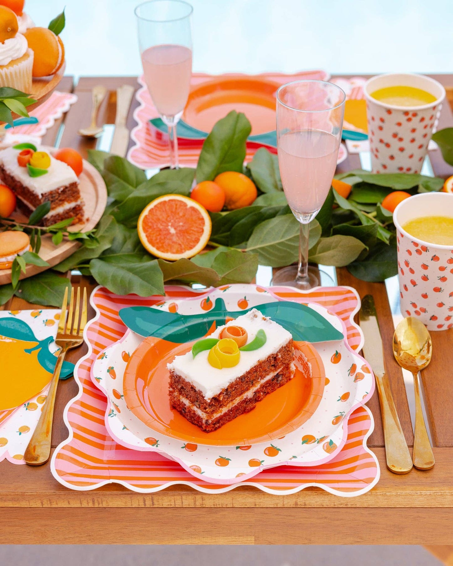 Citrus-themed table setting with orange-shaped plates and decor.
