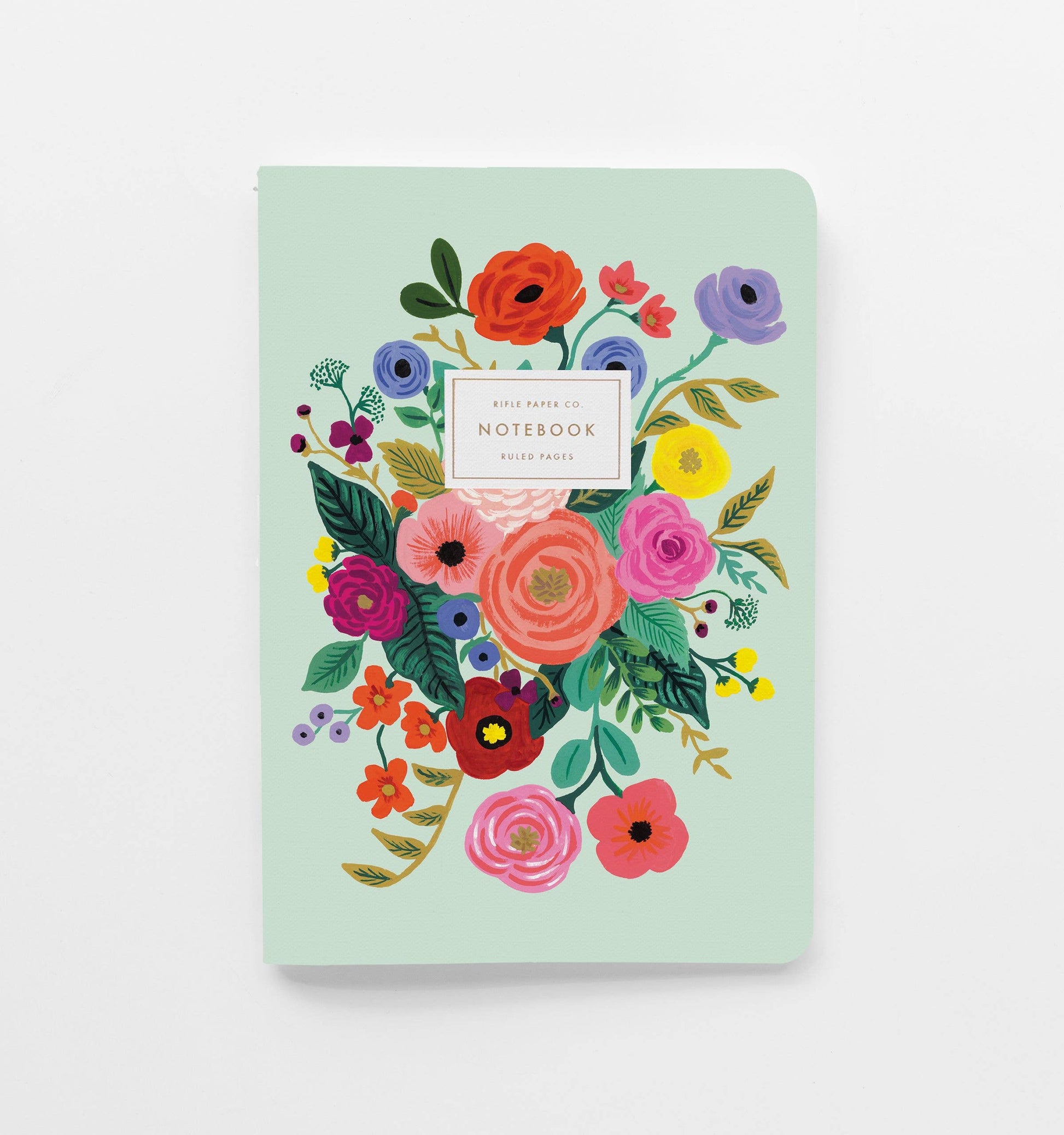 Teal notebook with floral design on a white background