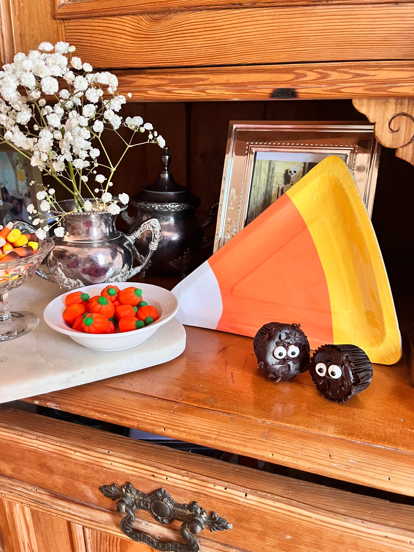 Lifestyle image of candy corn plates and other Halloween decor.