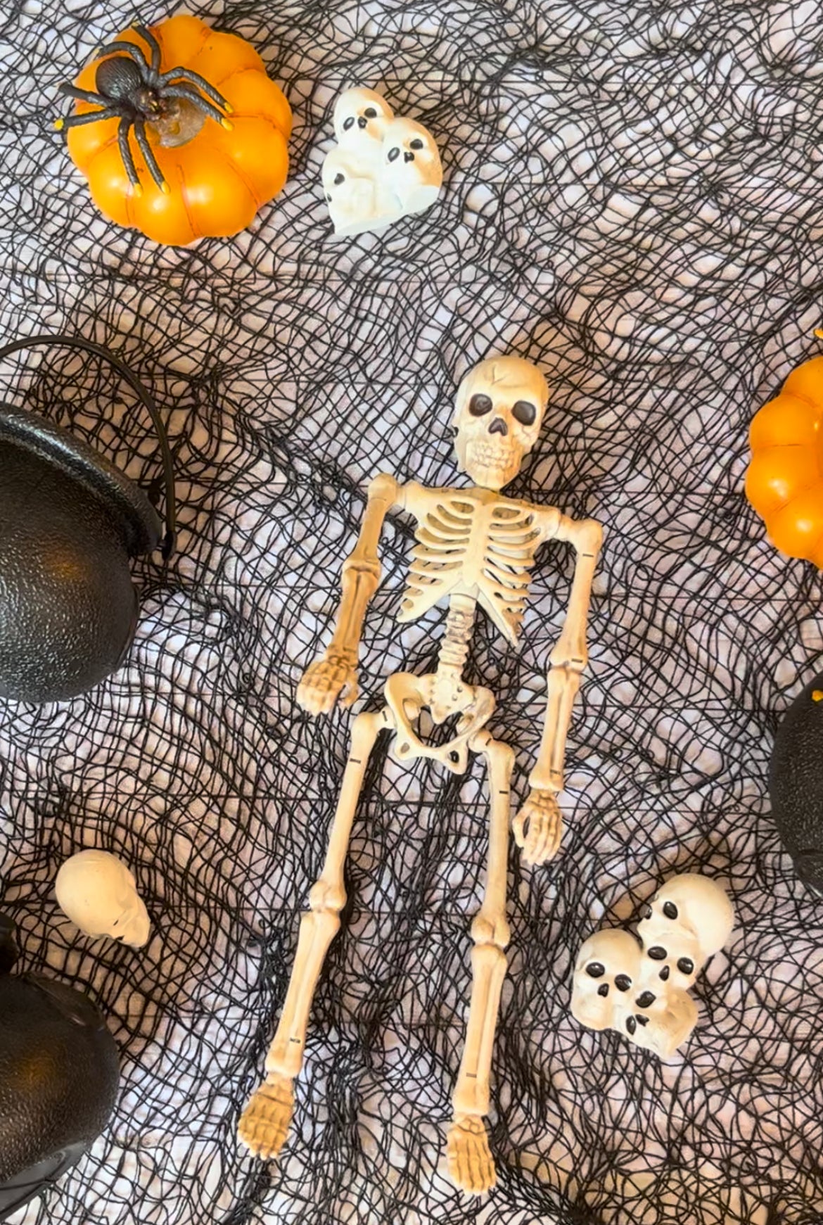 Image of skull table scatter with other Halloween decor items