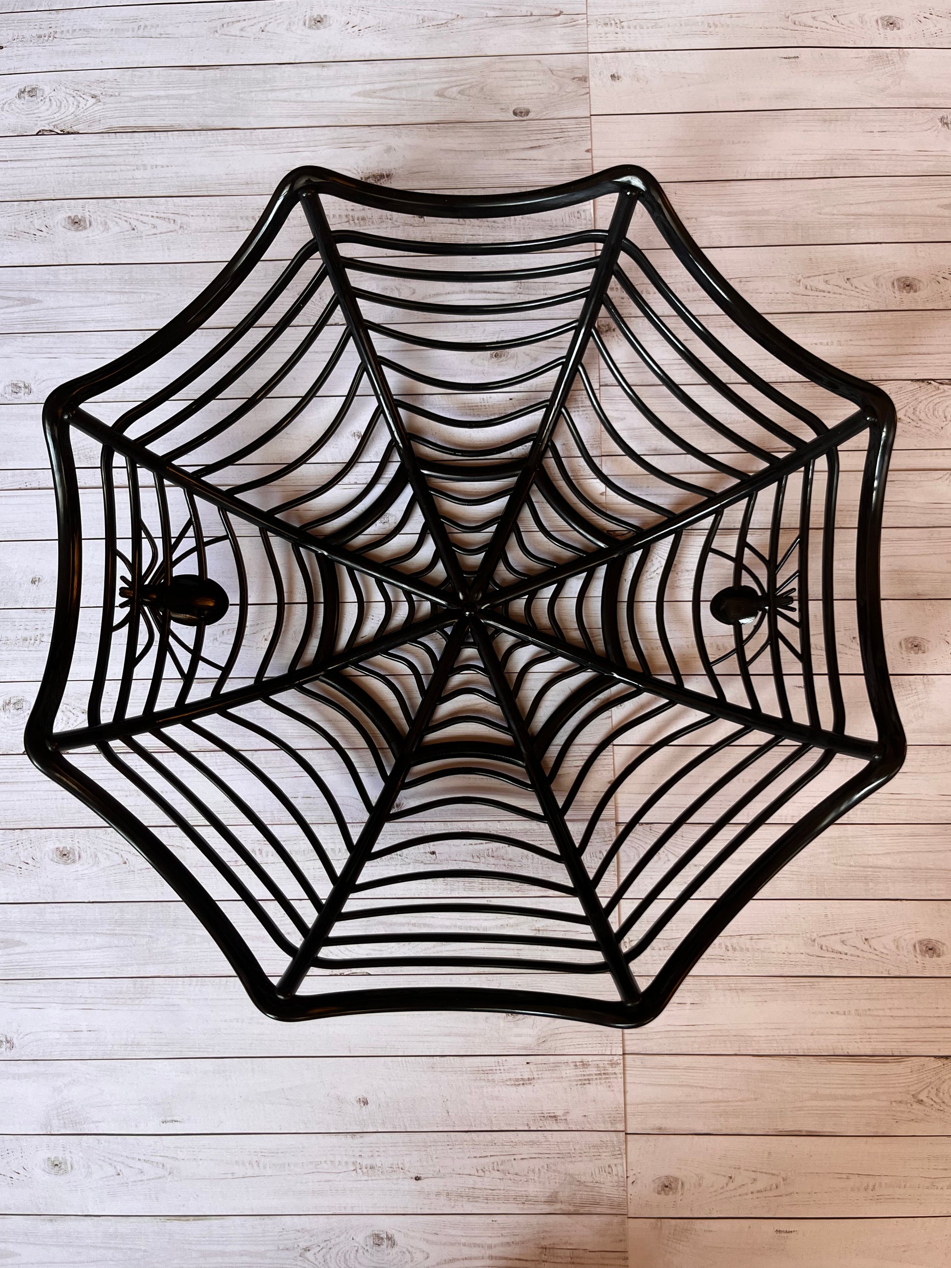 Black plastic candy bowl resembling a spider web