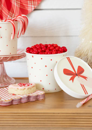 Lifestyle image of a red and white striped scalloped cocktail napkin