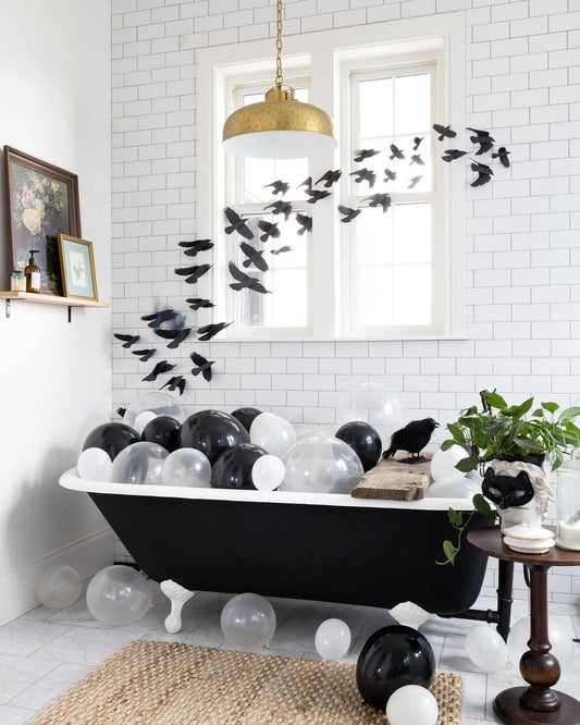 Image of a bathroom decorated with black glittered ravens as Halloween decor.