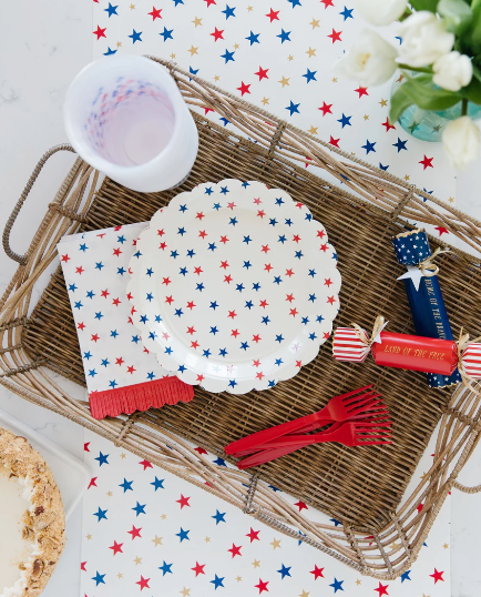 Scalloped round paper plate with allover star print