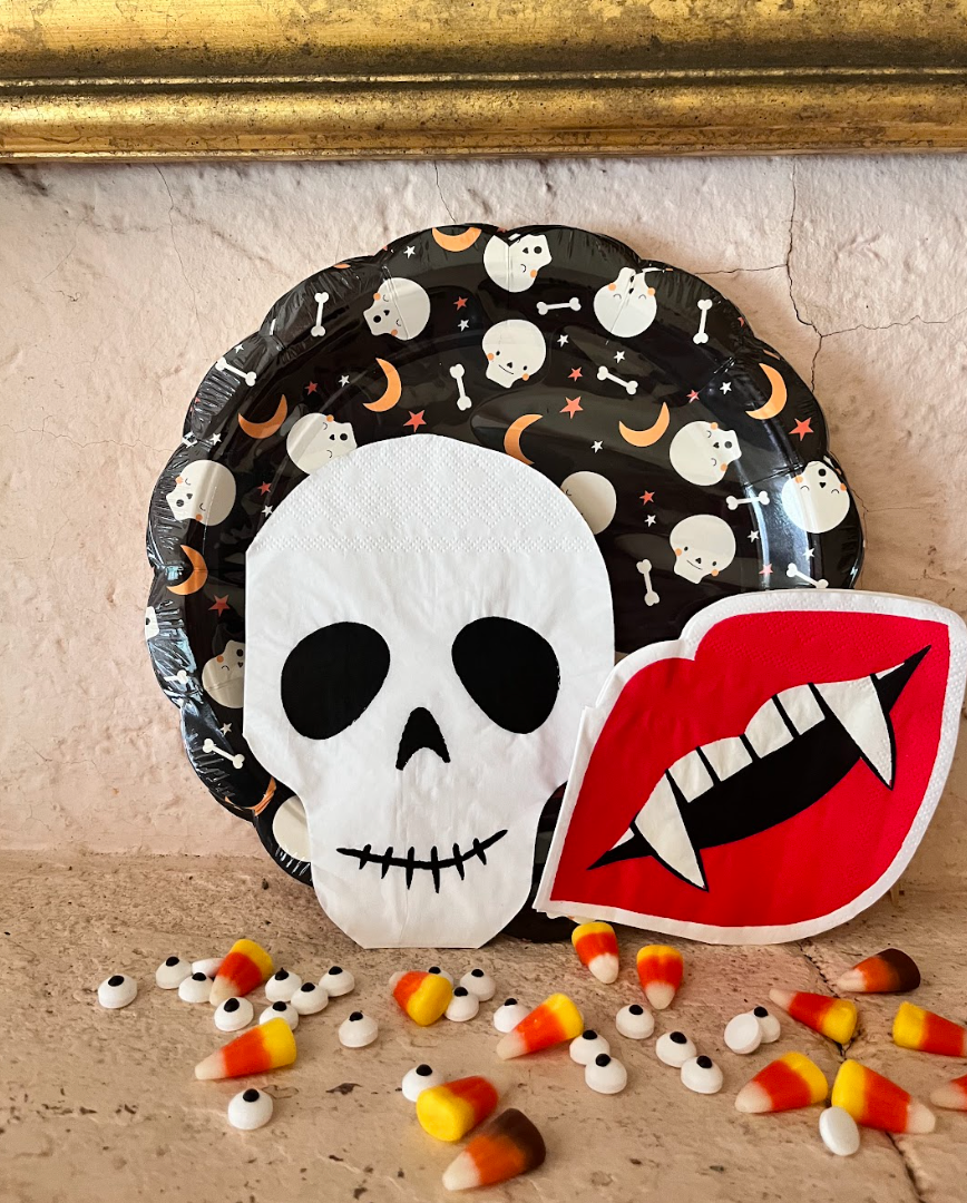 Lifestyle image of vampire lip napkins with other halloween plates and napkins