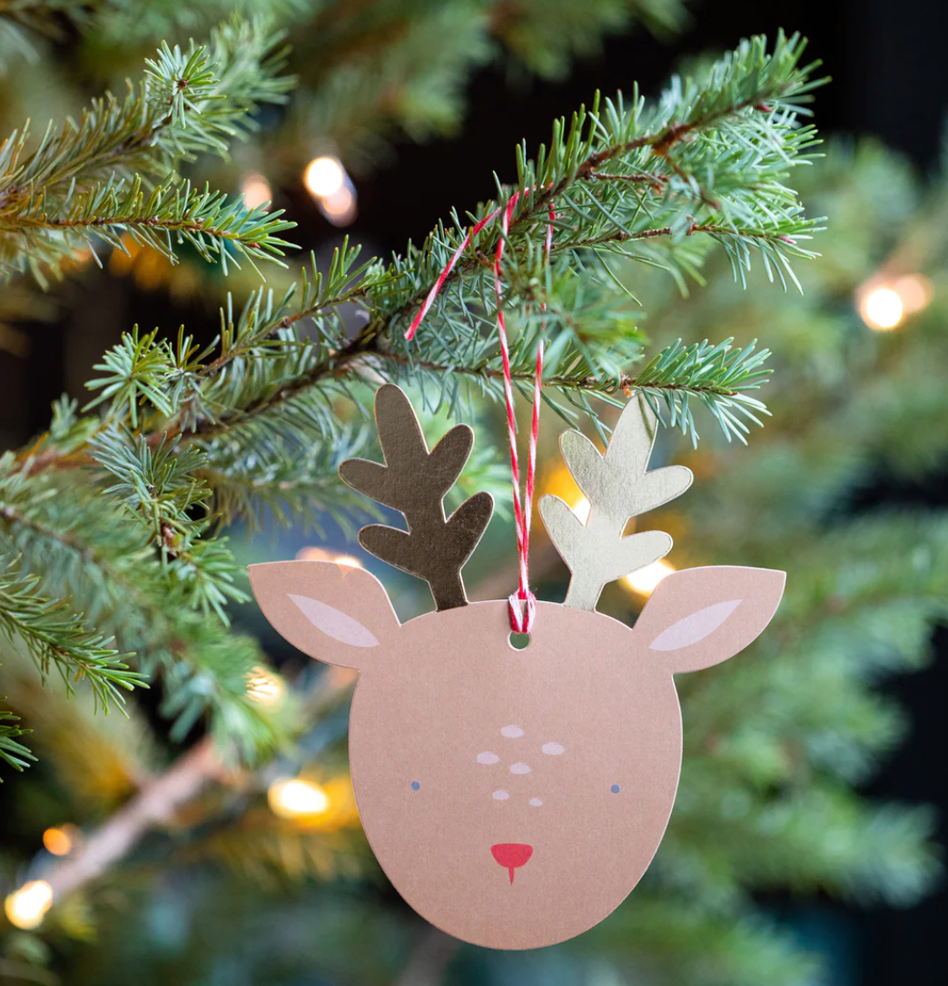 Image of a reindeer gift tag as an ornament on a Christmas tree