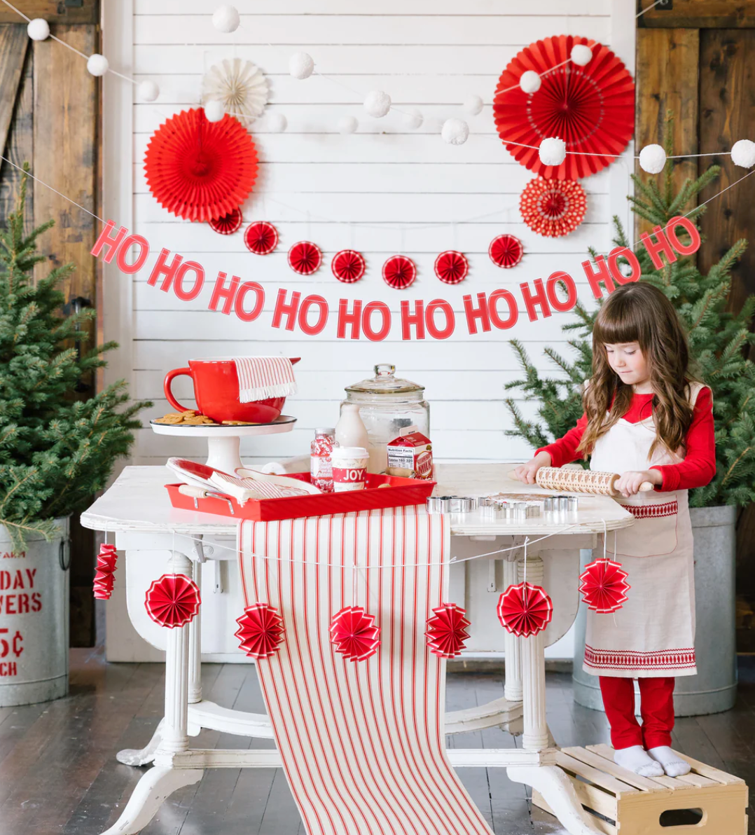 Image of a Christmas party featuring a red and white striped table runner