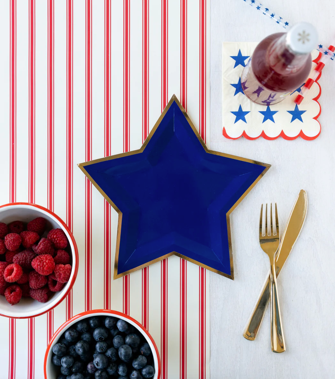 4th of July table setting featuring a red and white striped table runner