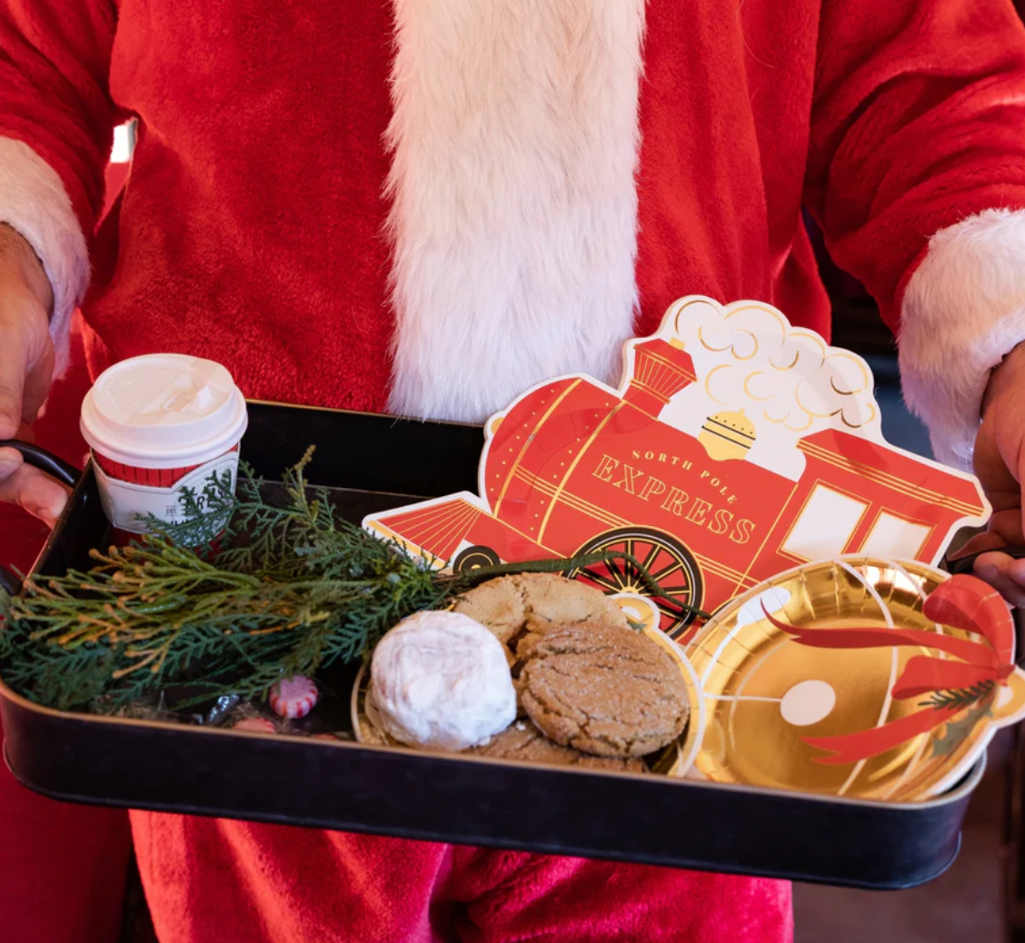 Image of Santa holding a tray of cookies and festive paper plates