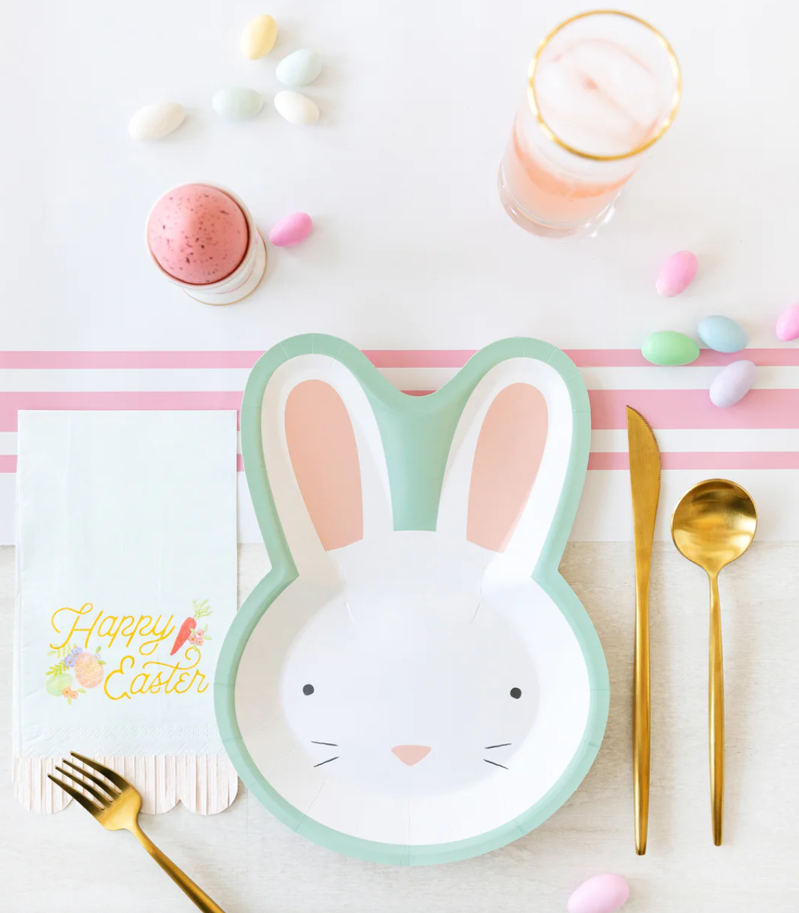 Image of a pink-and-white striped table runner on a decorated Easter table.