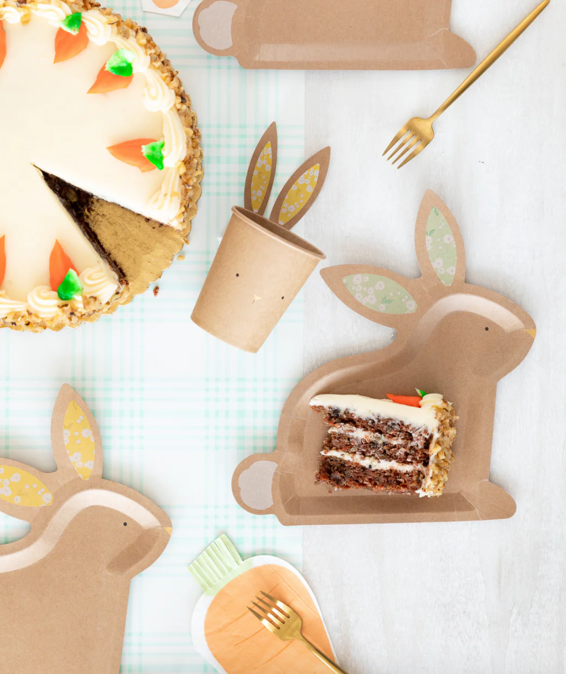 Front image of a carrot-shaped paper napkin on a decorative Easter table.