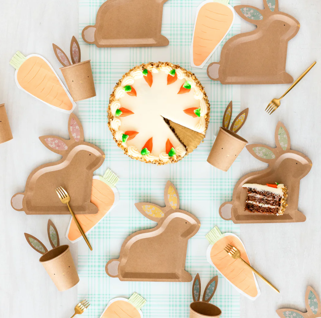 Front image of a carrot-shaped paper napkin on a decorative Easter table.