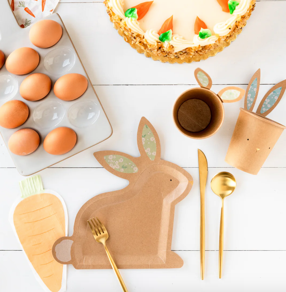 Front image of a carrot-shaped paper napkin on a decorative Easter table.