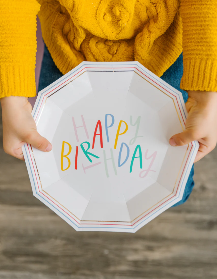 Image of a child holding a happy birthday plate