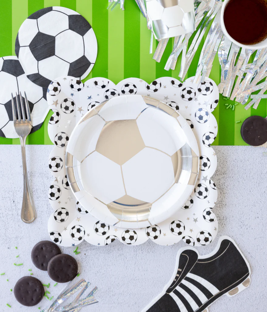 Image of a die-cut soccer ball napkin on a party table laydown