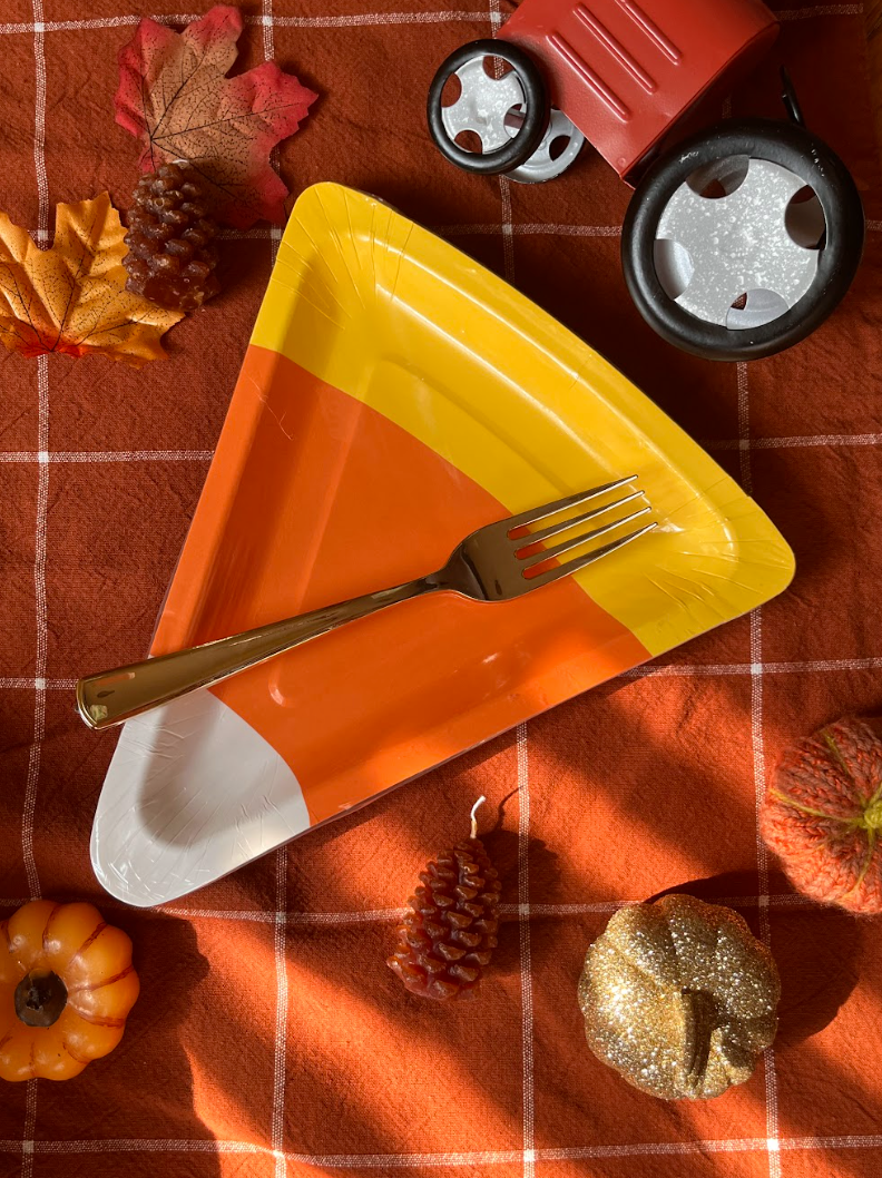 Lifestyle image of candy corn plates and other Halloween decor.