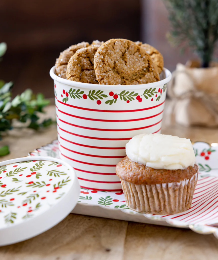 Lifestyle image of a square scalloped Christmas plate featuring red and green holly berries