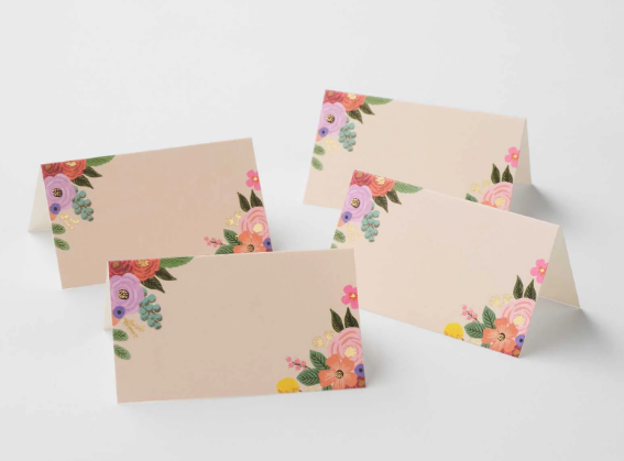 Set of four floral place cards on a white background
