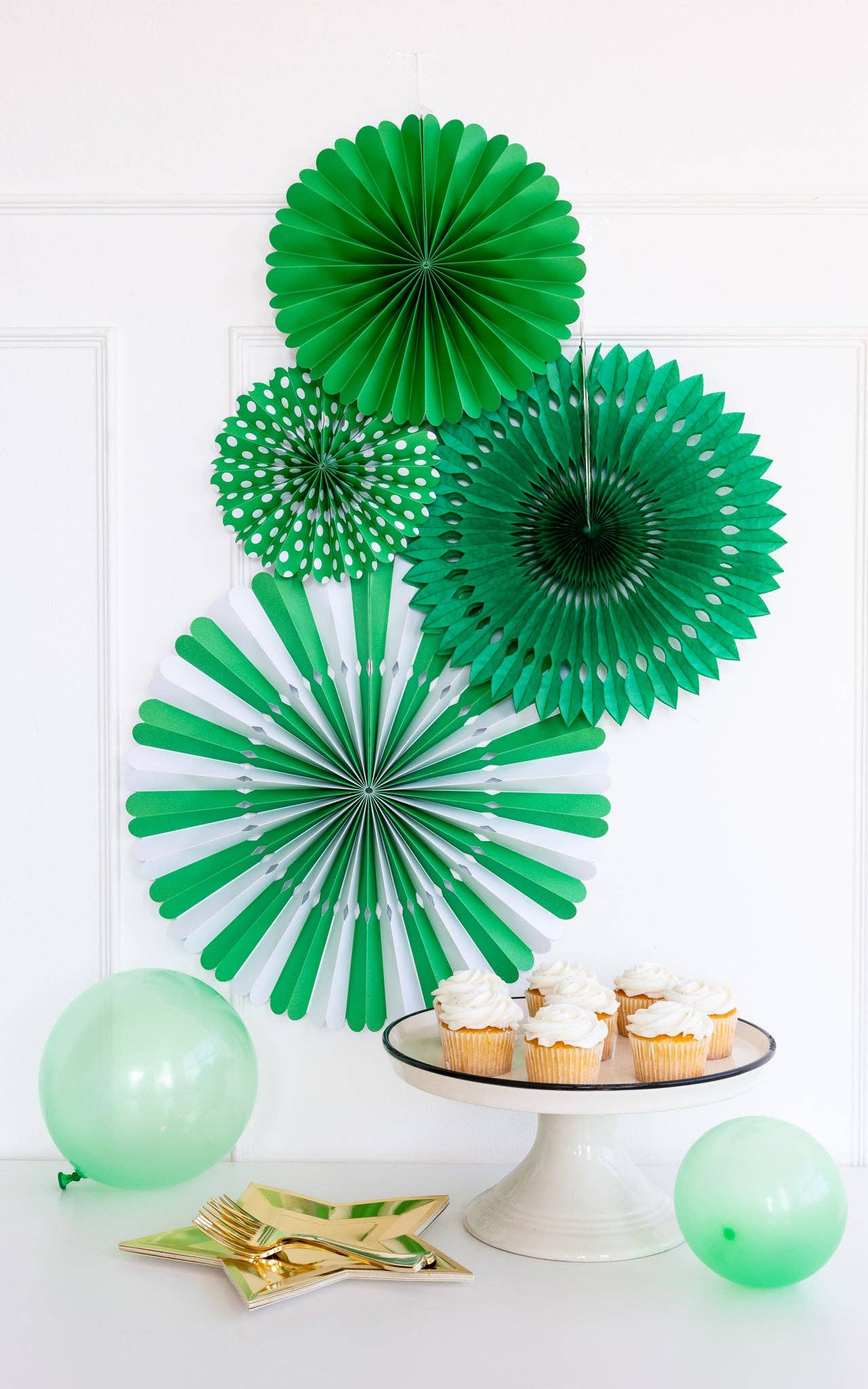 Party scene with green paper fans and gold star-shaped plates