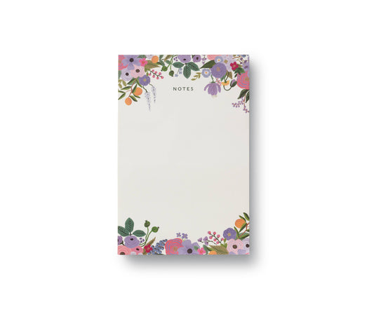 Purple floral notepad with decorative border on a white background