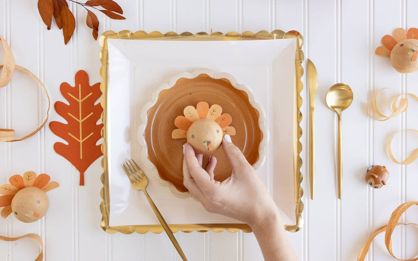 large white square paper plate with gold scalloped edge detail