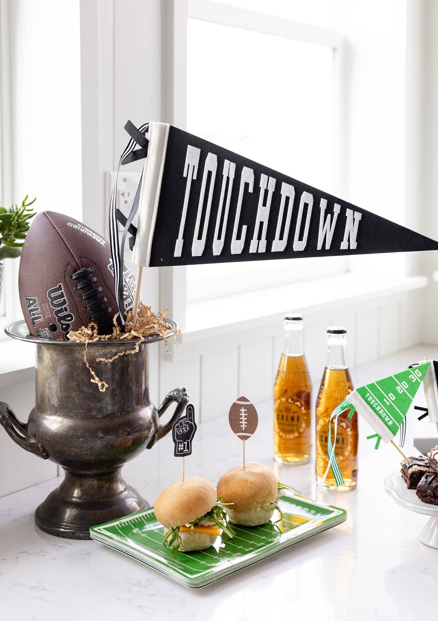 Football-themed appetizers with a 'Touchdown' banner on a table.