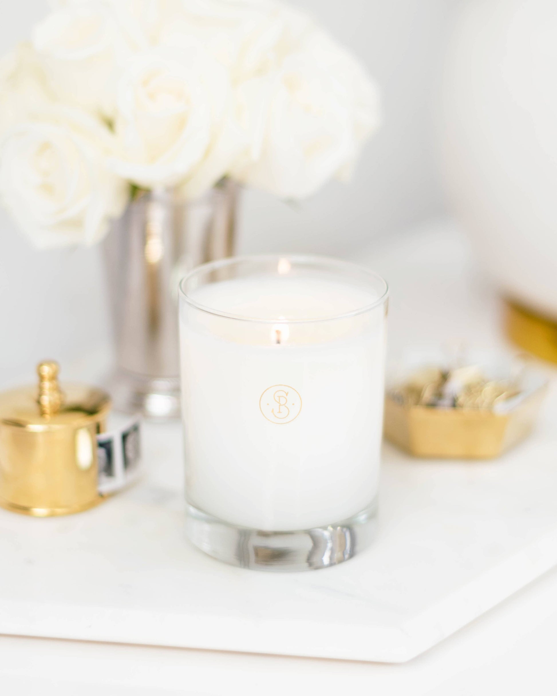 Clear glass candle on a white surface