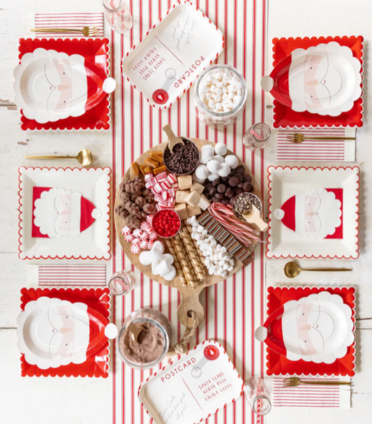 Birds eye view of a Christmas tablescape featuring Santa face shaped paper plates