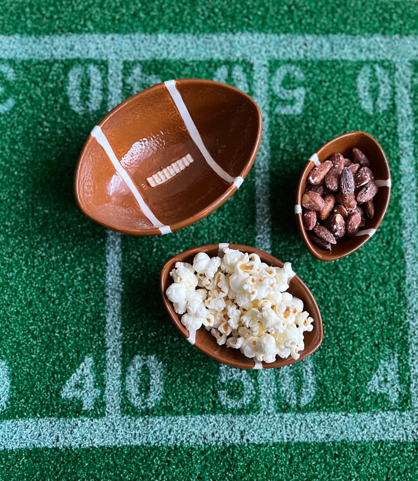 Football food bowls on top of a game day table runner