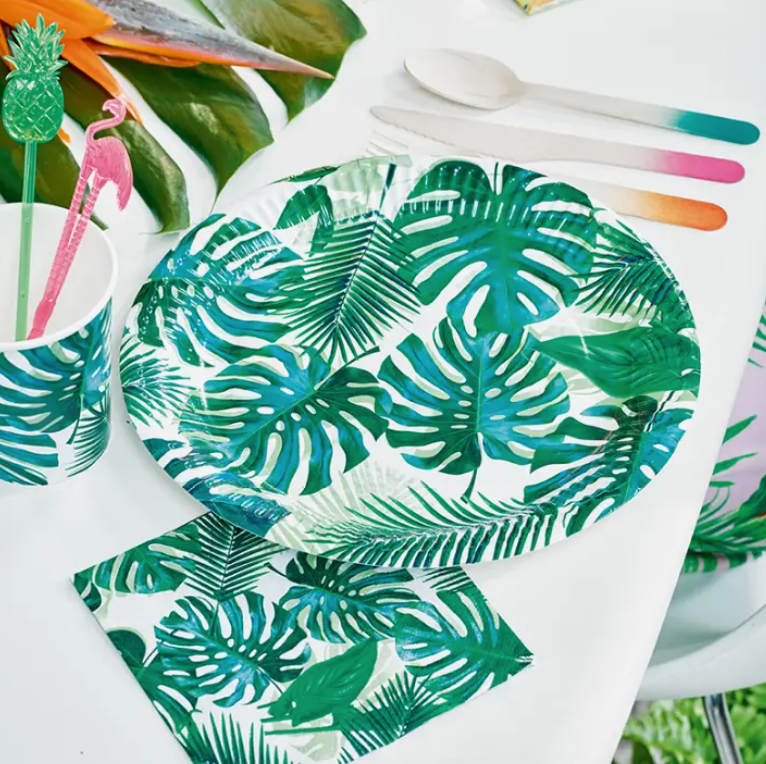 Product shot of tropical paper plate featuring green leaves in situation on a table