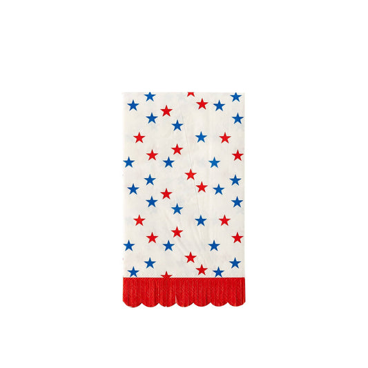 Single image of a white dinner napkin with red and blue stars and a red scalloped edge